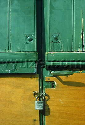 Green shutters and padlock / Location: Greece