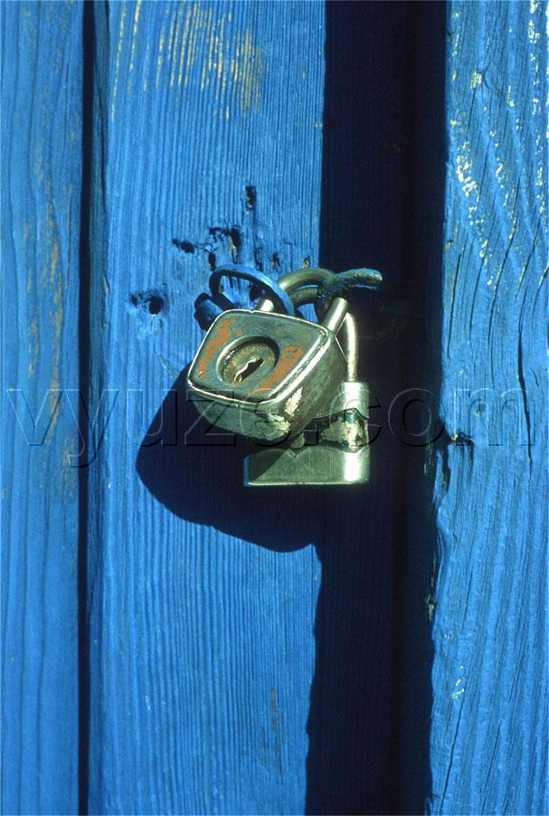 Padlock on blue door / Location: Greece