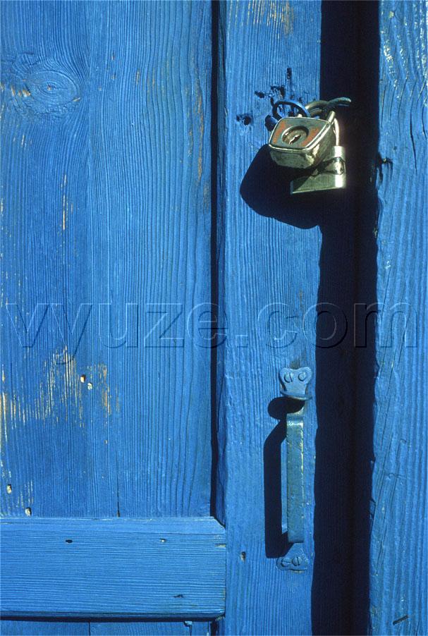 Padlock on blue door / Location: Greece
