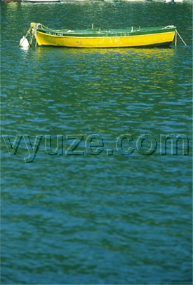 Yellow boat on mooring / Location: Greece